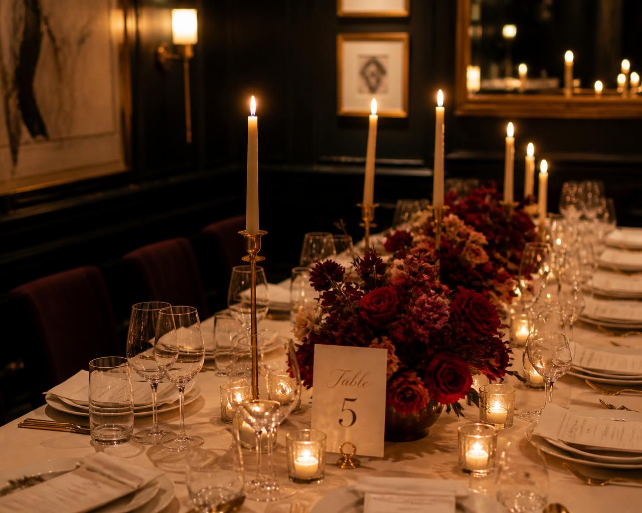 Private dining room birthday table with candles and burgundy florals